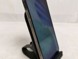 a cell phone that is on a stand on a table