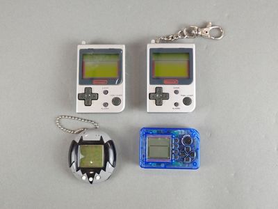 two game controllers and a keychain sitting on a table
