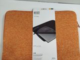 packaging of an orange laptop sleeve on a white surface