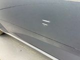 a close up of a car ' s door handle and the door handle of the car