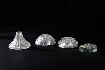 three clear glass vases sitting on top of a black surface