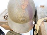 a helmet sitting on top of a pile of luggage