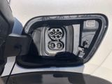 a close up of a car ' s rear view mirror with a plugged in