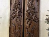 two large wooden doors with intricate designs on them in a room