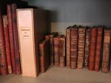 many old books on a shelf in a room