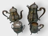 two silverplated teapots and a coffee pot on a white background