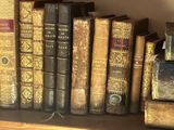 many old books sitting on a shelf in a library