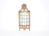 un petit miroir avec un cadre doré et une horloge dessus