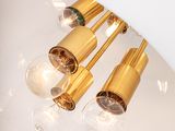 three light bulbs that are on a white lamp