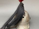 a helmet with a long black hair on top of it