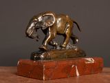 a statue of an elephant standing on a marble block