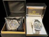 two watches that are in a box on the table