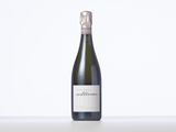 a bottle of wine sitting on top of a white table