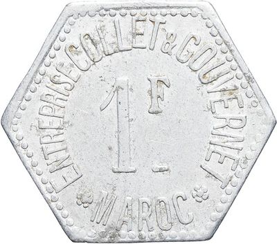 a close up of a silver coin with the number one on it