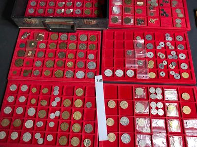 a lot of coins in a red box on a table