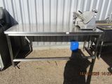 a stainless steel table with a blue bucket on it