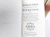 someone is holding a book open to show the title of the book