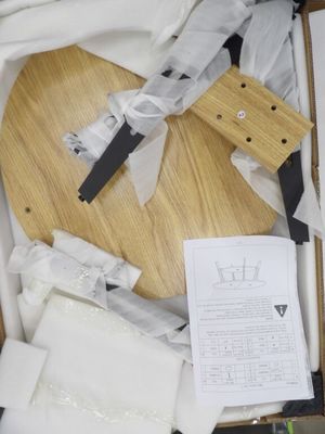 a box with a knife, cutting board, and other items in it