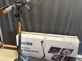 a scooter that is sitting on the floor next to a box