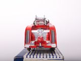a toy fire truck sitting on top of a book