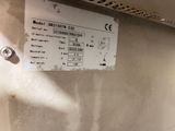 a sign on the side of a wall stating that there is a water heater