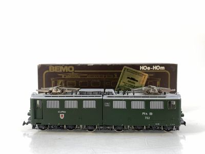 a toy train on a white surface with a box