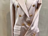 pink jacket with gold buttons on a mannequin base