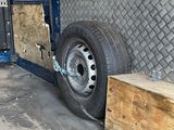 a truck that is parked in a garage with a ramp