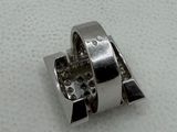 a close up of a silver ring on a white surface