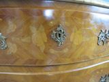 an image of a wooden dresser with metal handles