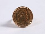 a small coin sitting on top of a white surface