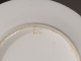 a white plate that has a brown line on it