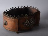 an image of a wooden box with a metal decoration on it
