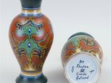 two vases sitting next to each other on a table