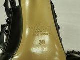 black high heeled shoes with spikes on the toes