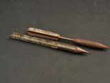 two pencils that are sitting on a table