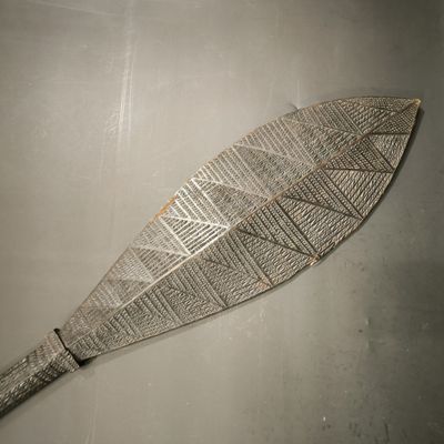 a wooden paddle that has a pattern on it