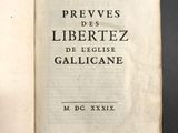 un livre ouvert posé sur une table, sur fond noir
