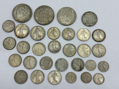 une pile de pièces d'argent posée sur une surface blanche