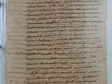 an old document with writing on it sitting on top of a table