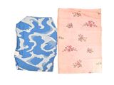 two pieces of cloth with a pattern on them sitting next to each other