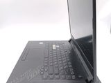 a laptop that is open on a white surface