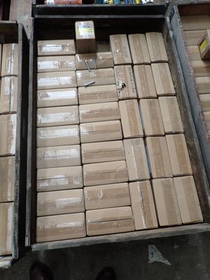 two boxes of books on a table with a person standing next to them