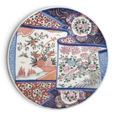 a decorative plate with a bird and flowers on it