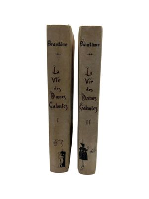 pair of old books with writing on them sitting on a white surface