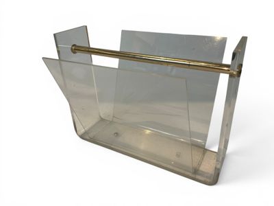 a clear magazine holder with a gold handle