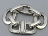 a close up of a metal bracelet on a table
