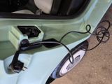 a car that has a charger plugged into the side of it