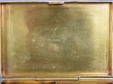 an image of a gold box with a gold lid on a blue surface
