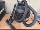 a small table with a vacuum and other tools on it